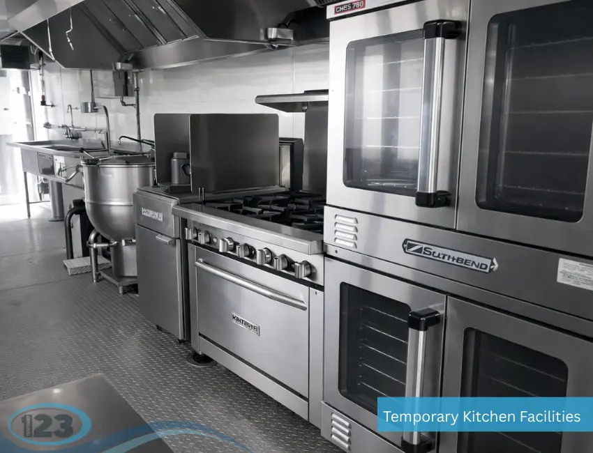 Commercial mobile kitchen with ovens, gas ranges, and stainless steel appliances for large-scale meal production.