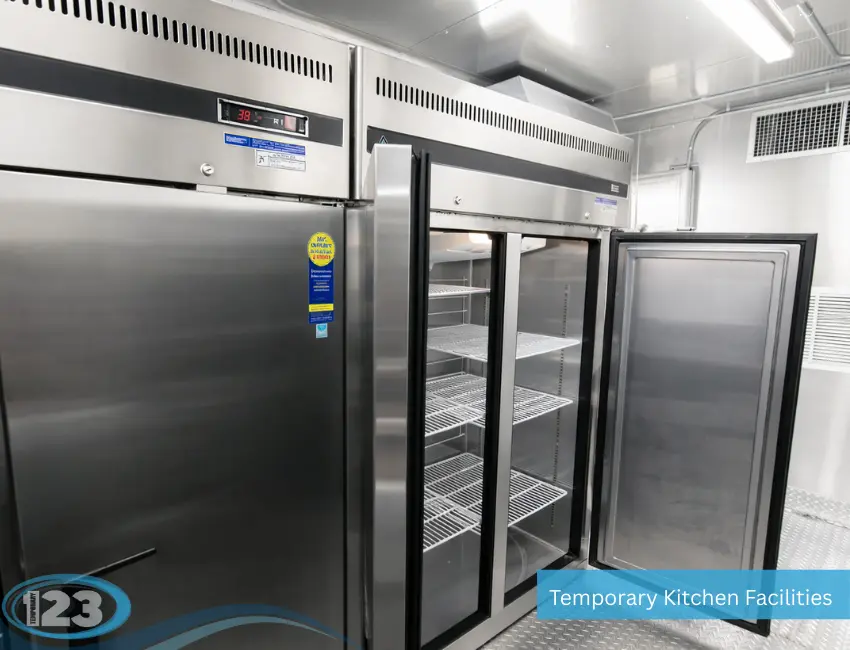 Stainless steel commercial reach-in refrigerators providing refrigerated food storage inside a mobile kitchen trailer.